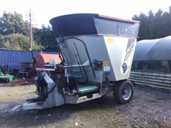 A small grain silo parked in a field, powered by the Shelbourne Power Mix Pro Express 13.